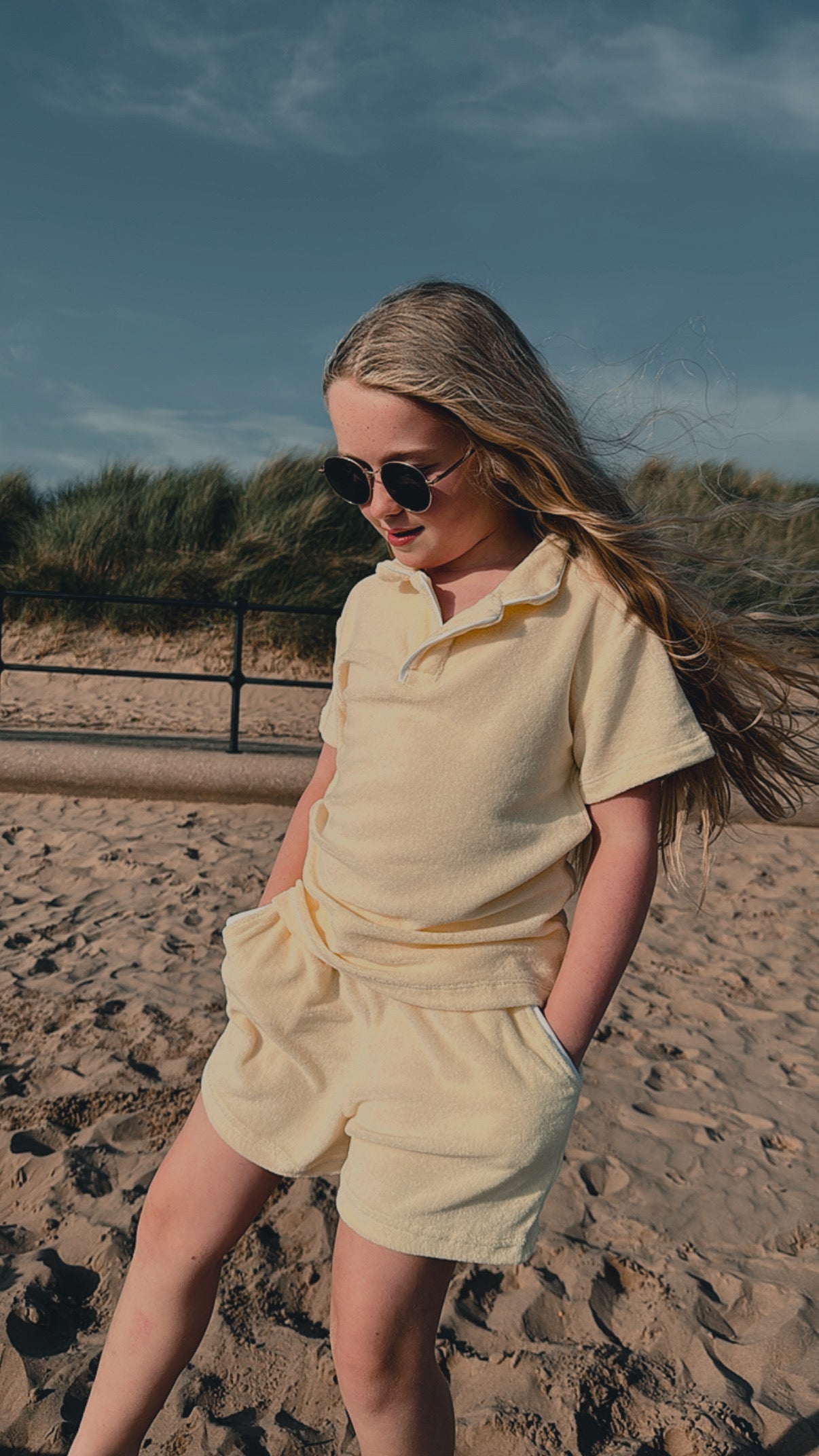 Lemon towelling short set with polo-style top and drawstring shorts, walking pose