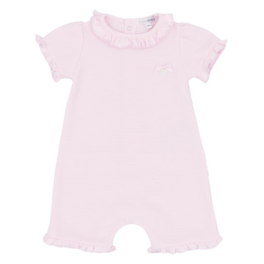 Pink baby romper with ruffled details on a white background