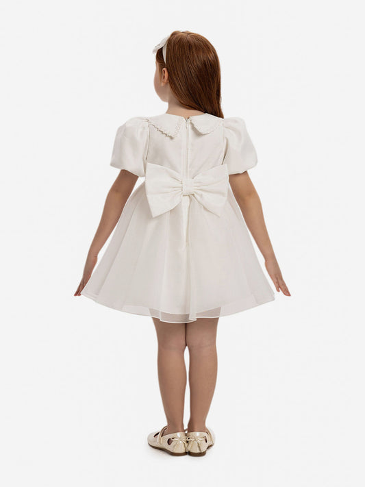 White baby dress back view with gathered waist and large bow at back