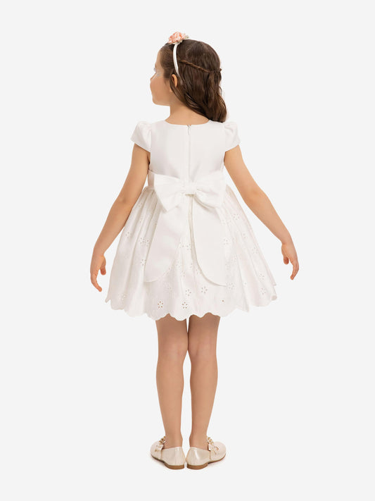 White baby dress back view with bow at waist and scalloped eyelet skirt