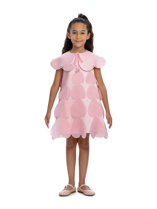 Pink heart-printed occasion dress with matching cape worn by a girl