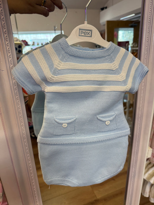 Baby outfit with striped vest and shorts on a hanger in front of a mirror.