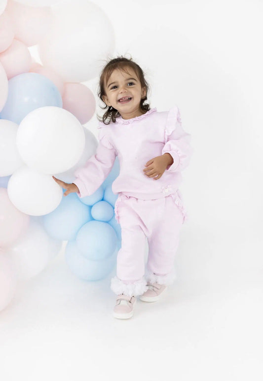 Pink baby jogger set on toddler: long-sleeve top with ruffle trim and joggers