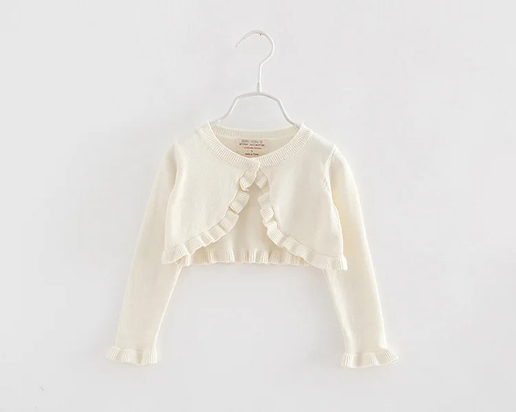 White toddler knit cropped cardigan with long sleeves, bow neckline and ruffled front