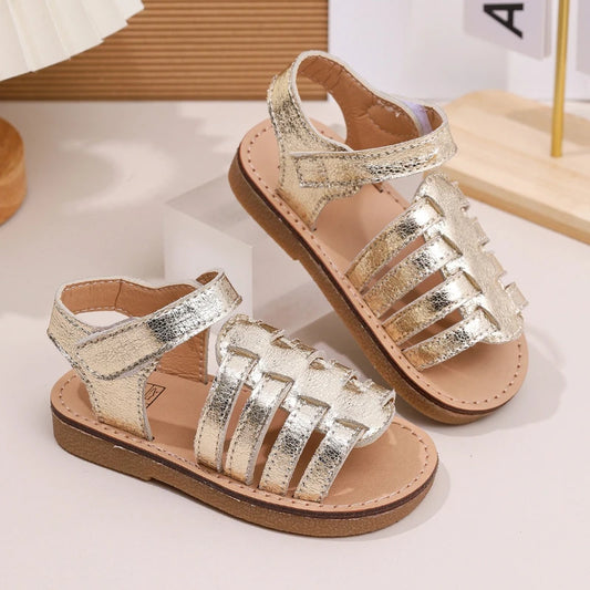 Girls gold Velcro sandals, crisscross front straps and tan rubber outsole