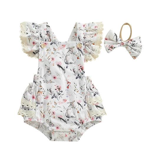 Floral baby romper with ruffles and matching headband on a white background