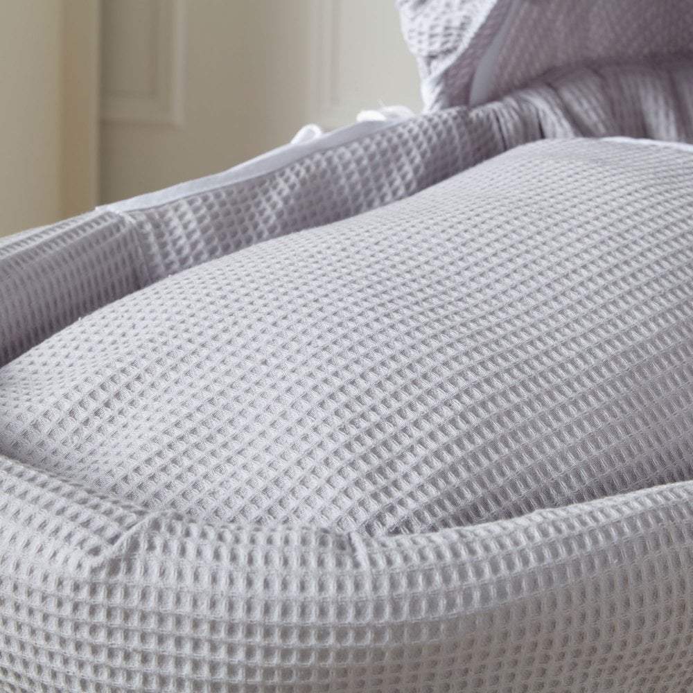 Grey waffle fabric close-up with raised square weave texture