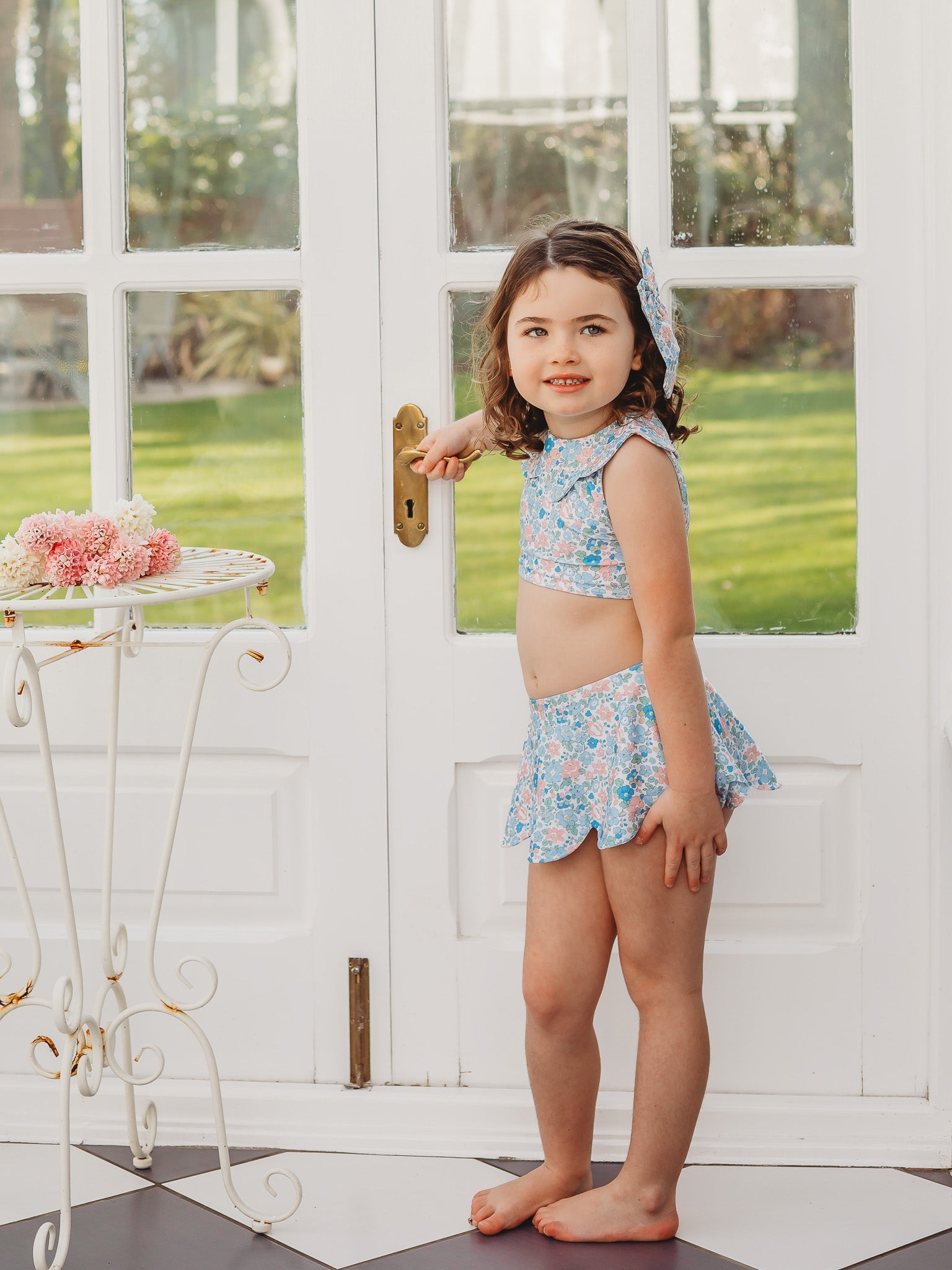 Blue floral petal-collar bikini set with skirted shorts and bow detail