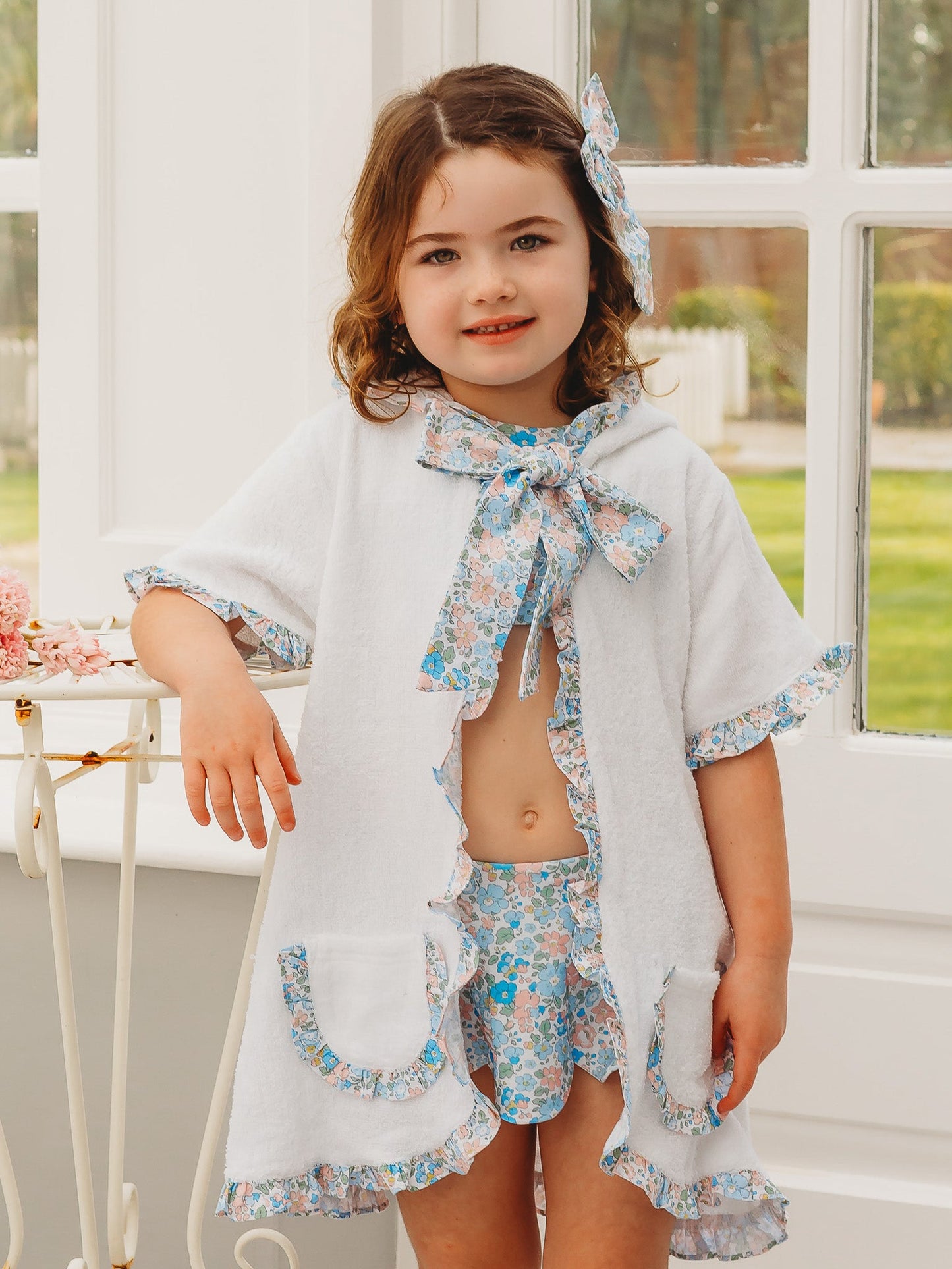 Hooded towelling poncho, light gray with blue floral trim and neck bow