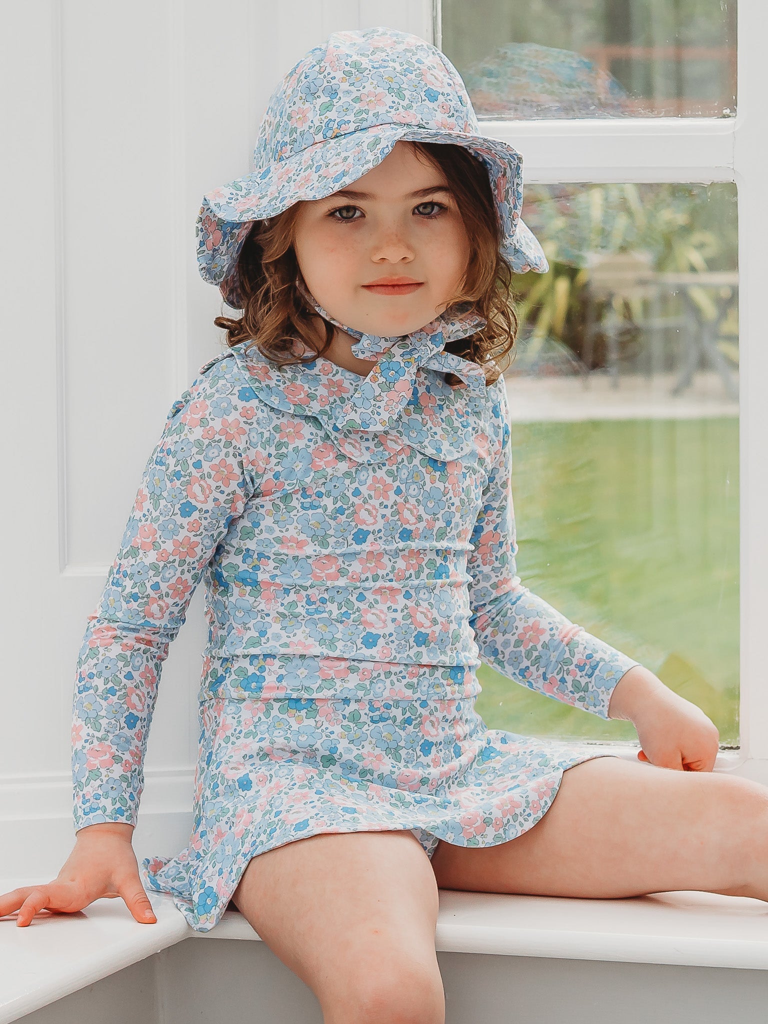Floral petal-collar long-sleeve skirted swimsuit in light blue, bucket hat