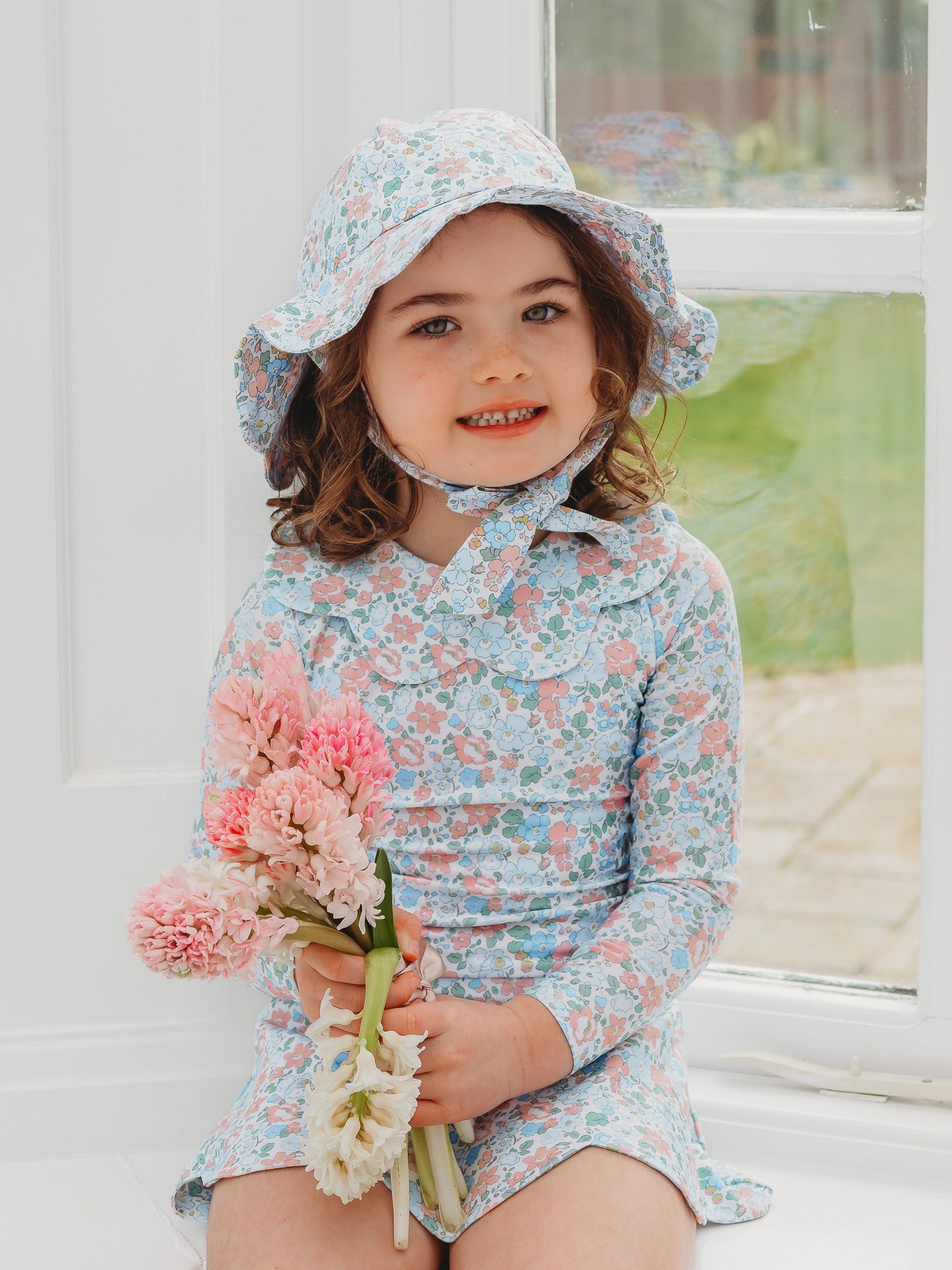 Floral petal-collar long-sleeve skirted swimsuit in light blue with bucket hat