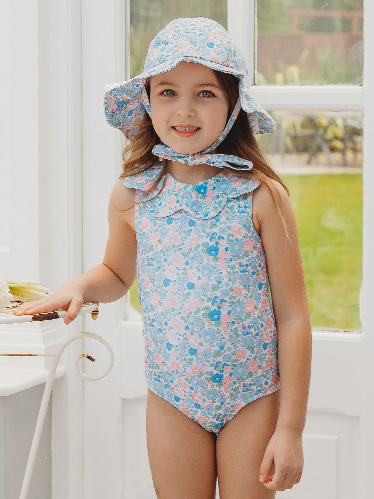 Light blue floral petal-collar sleeveless one-piece swimsuit on child