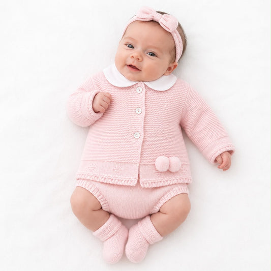 Baby outfit in pink knit: white-collared jacket, matching pants, booties, headband bow