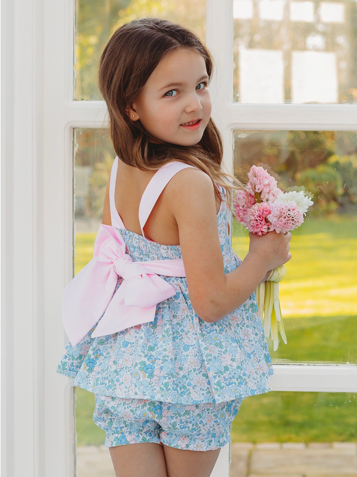 Floral bow-back bloomer set with pink bow detail, light blue floral ruffle dress