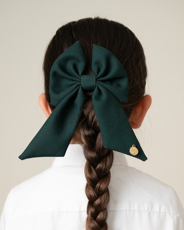 Bottle green kids school hairbow with gold charm, tied at back ponytail