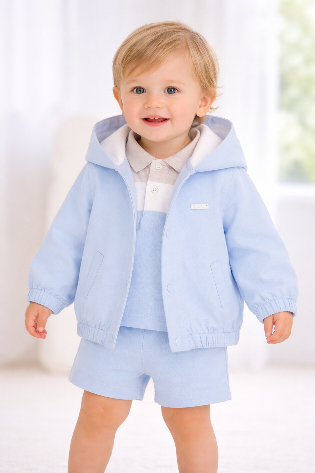 Blue hooded baby jacket with snap front and side pockets, ribbed cuffs