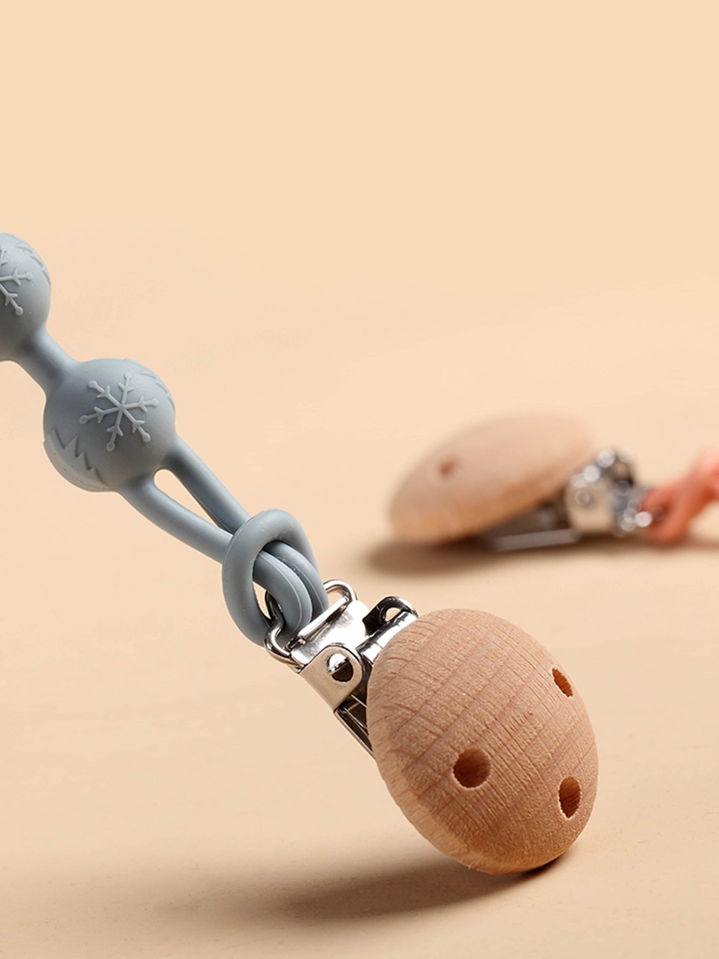 Pacifier clip with silicone loop and round wooden teether disc