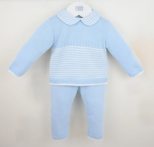 Light blue baby boys sweater and pants set on a beige background