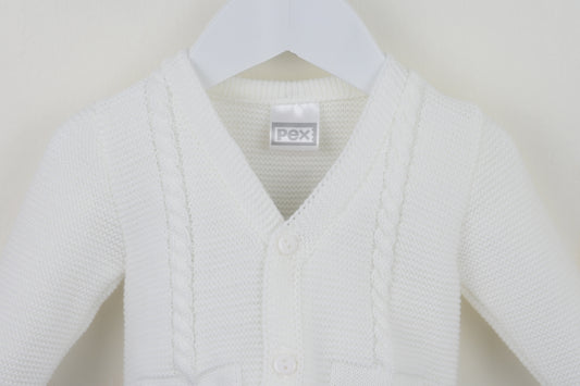 White baby cardigan on a hanger with a visible brand label against a plain background