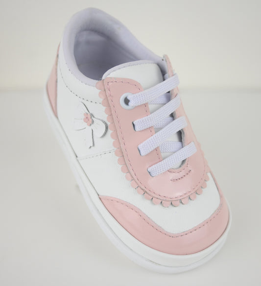 Pink and white sneaker on a light gray background