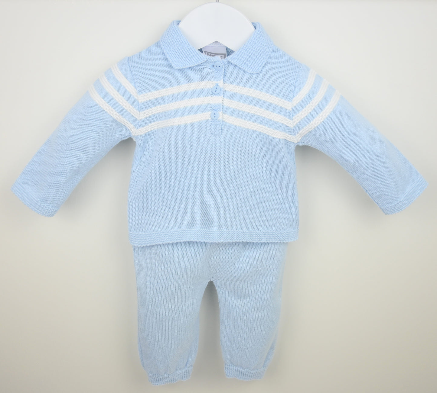 Light blue baby outfit with a striped shirt and pants on a beige background