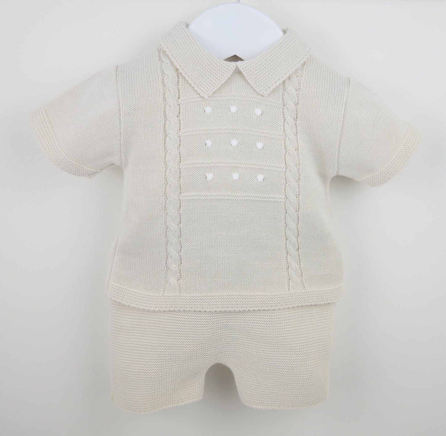 Beige baby romper with a collar on a white background