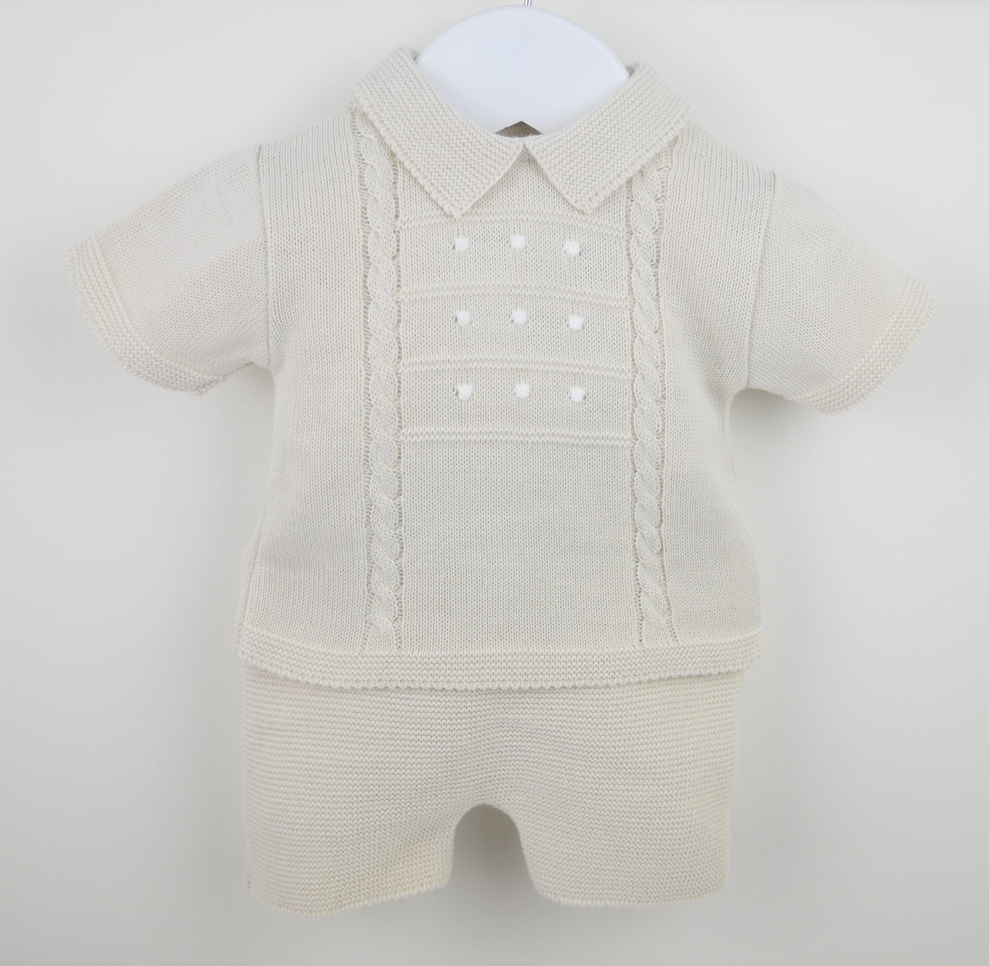 Beige baby romper with a collar on a white background