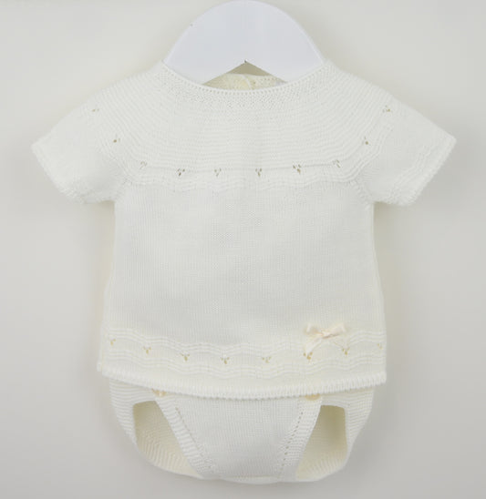White baby romper with short sleeves on a hanger against a light gray background