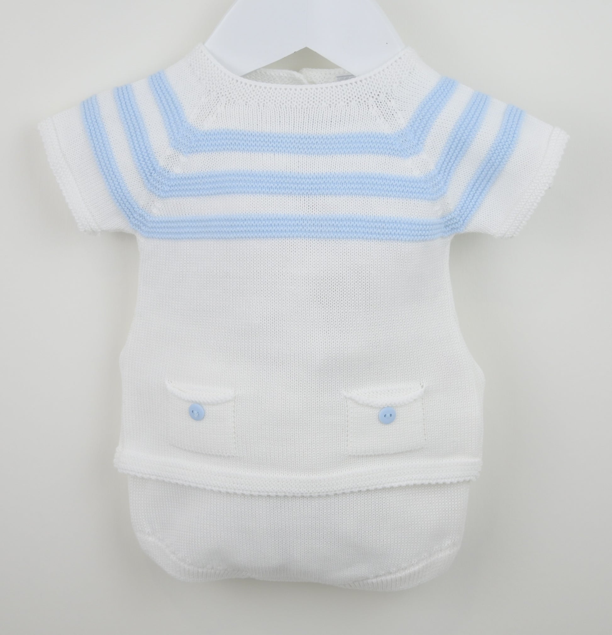 White baby outfit with blue trim on a hanger against a white background