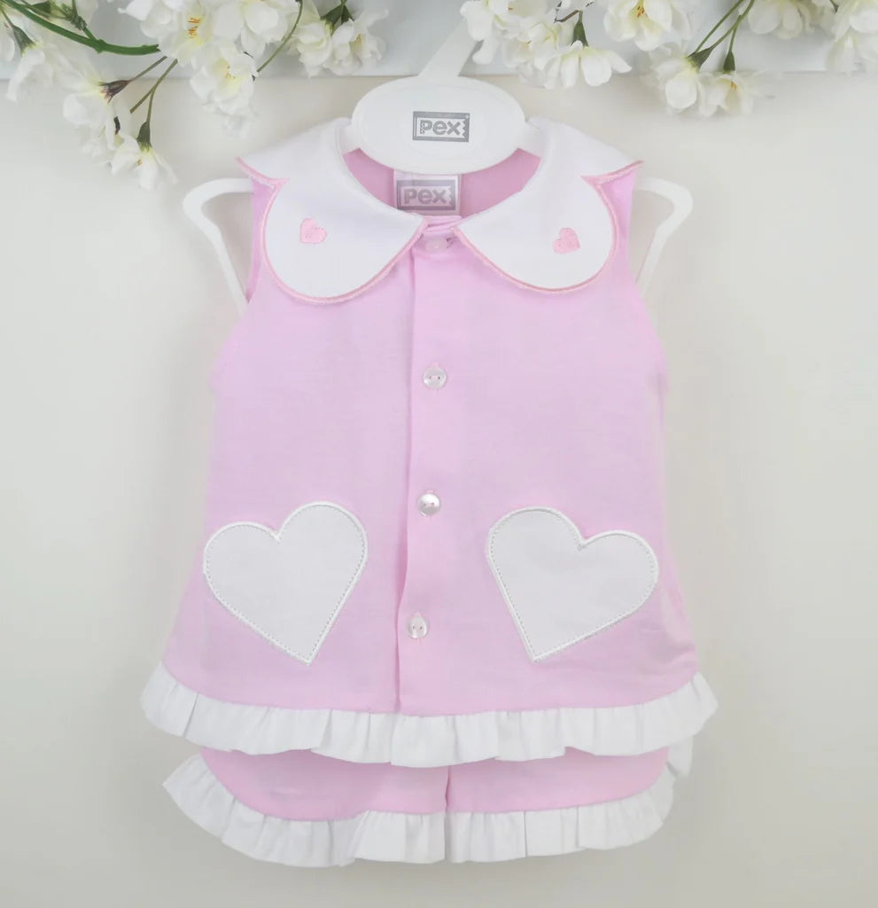 Pink sleeveless vest with button front, white heart applique and layered ruffle hem