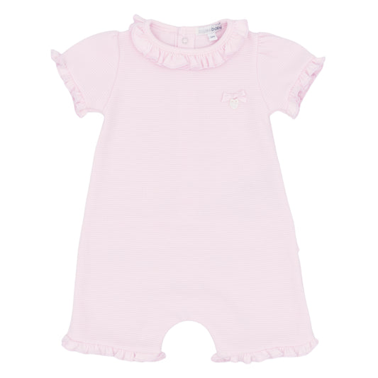 Pink baby romper with ruffled details on a white background