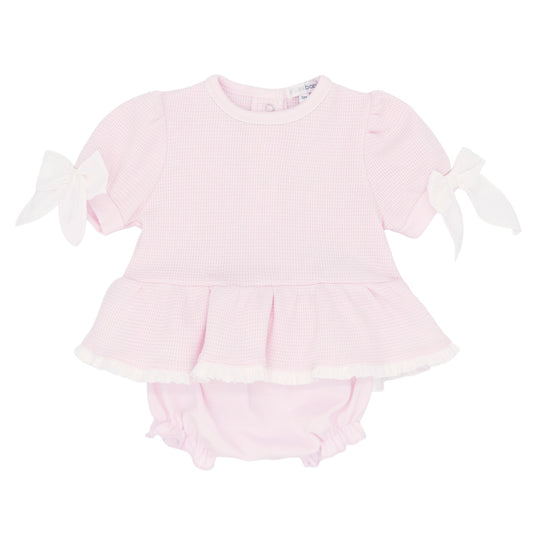 Pink baby romper with ruffled sleeves on a white background