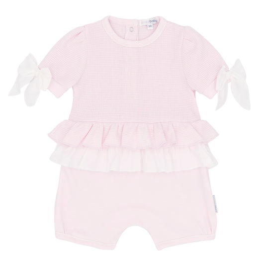 Pink baby romper with ruffled details on a white background