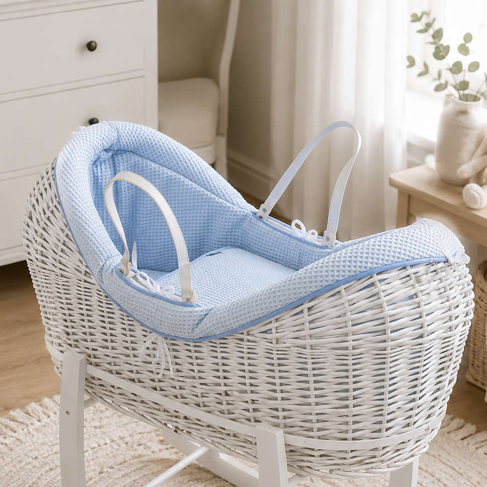 Wicker moses basket with light-blue textured carrycot insert and light-colored handle straps