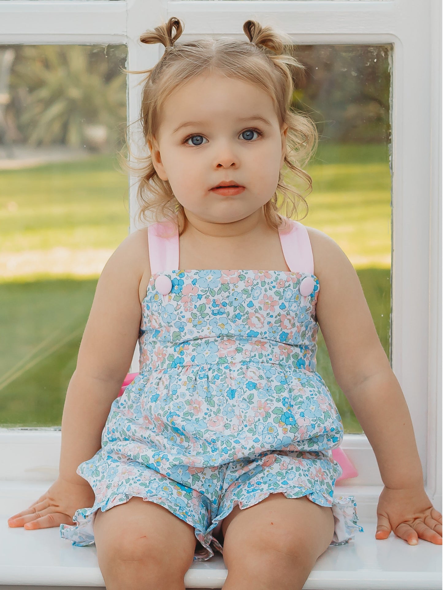 Floral playsuit with light blue print, pink ruffle trim, spaghetti straps