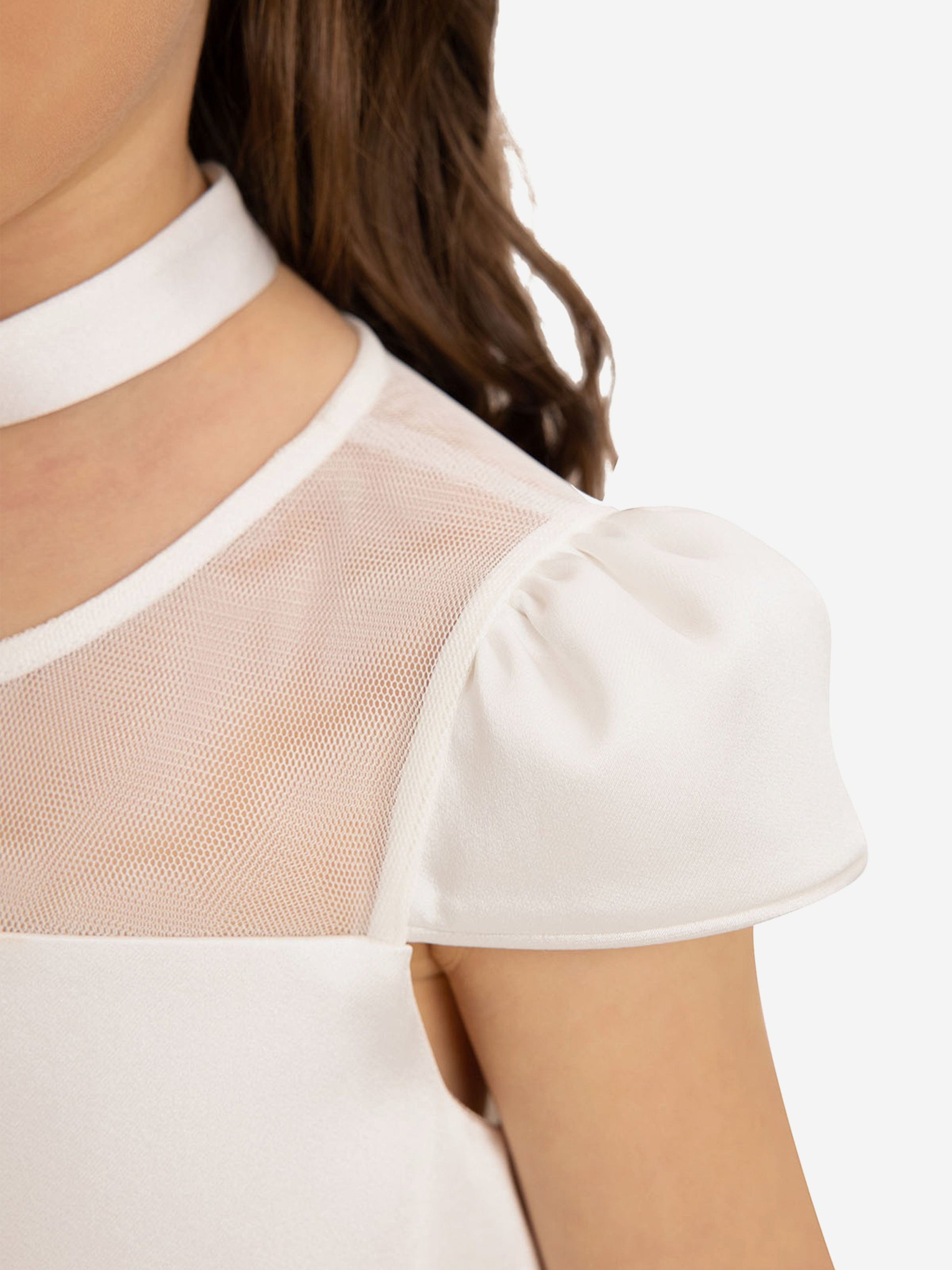 White dress with mesh yoke, puff sleeve caps, and flower choker at neckline