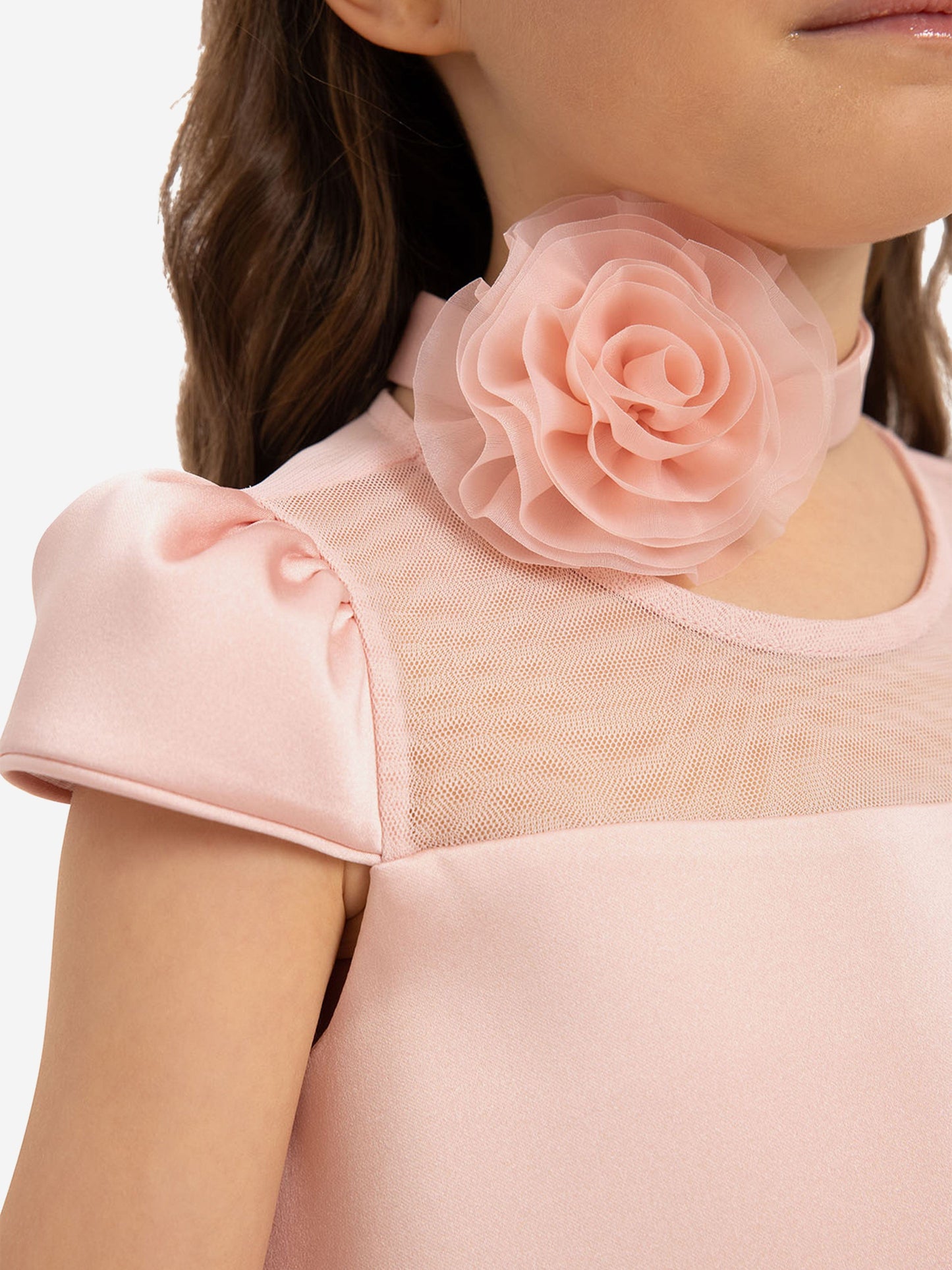 Pink flower choker on girls’ dress neckline with sheer mesh top panel