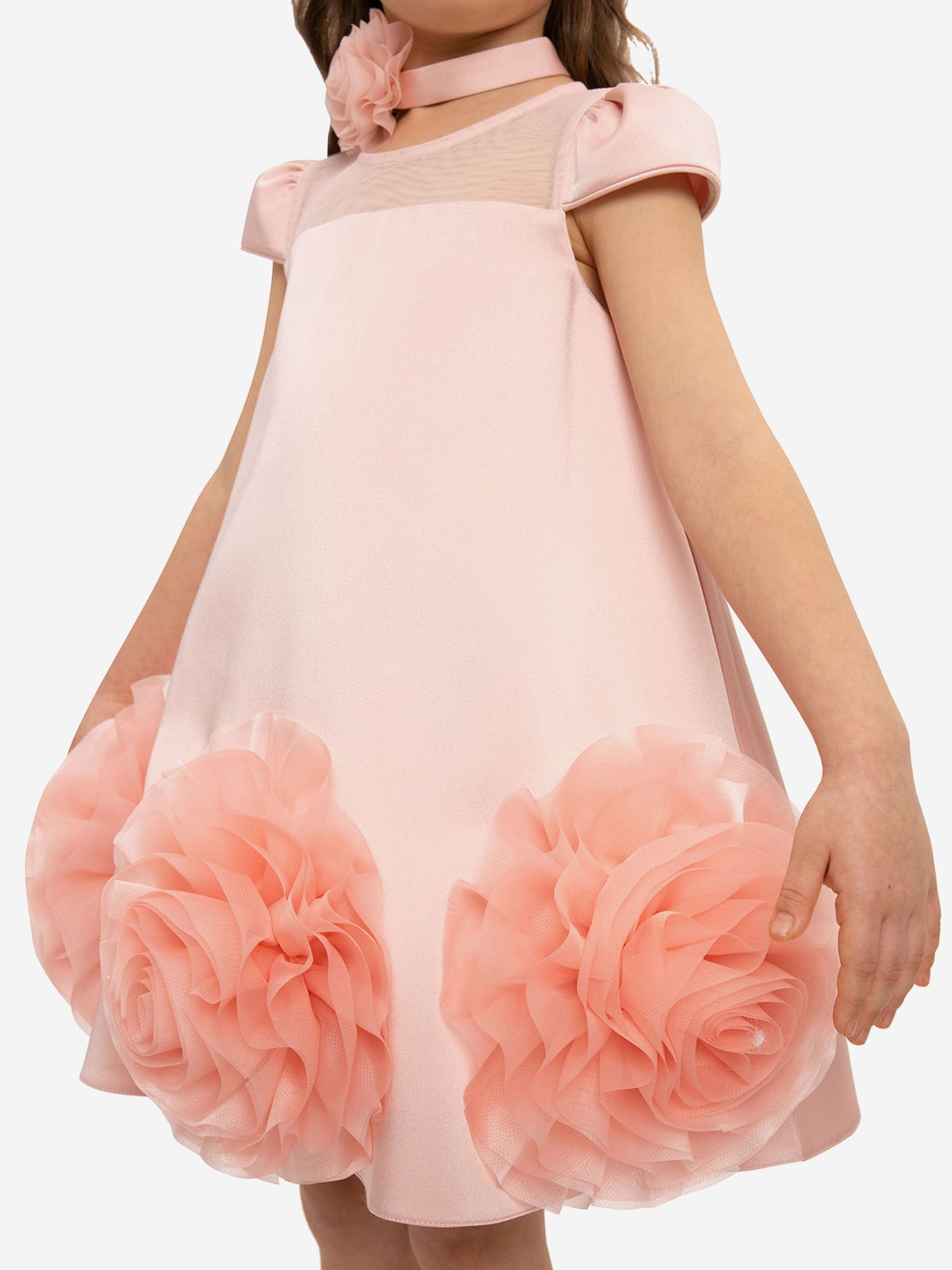 Pink girls’ dress with large tulle rosette appliqués at the skirt hem