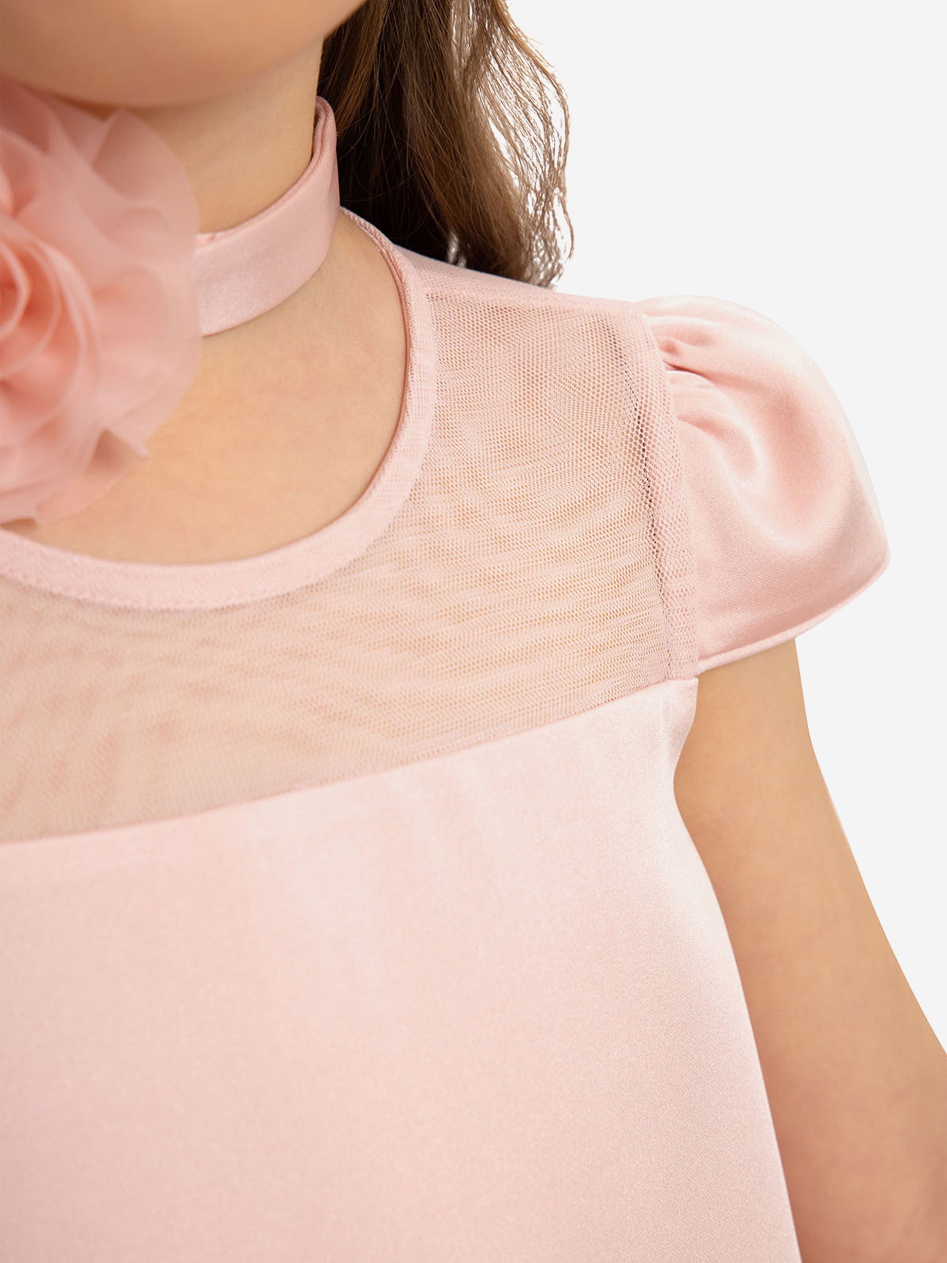 Pink mesh yoke and short puff sleeves on girls’ dress neckline and bodice