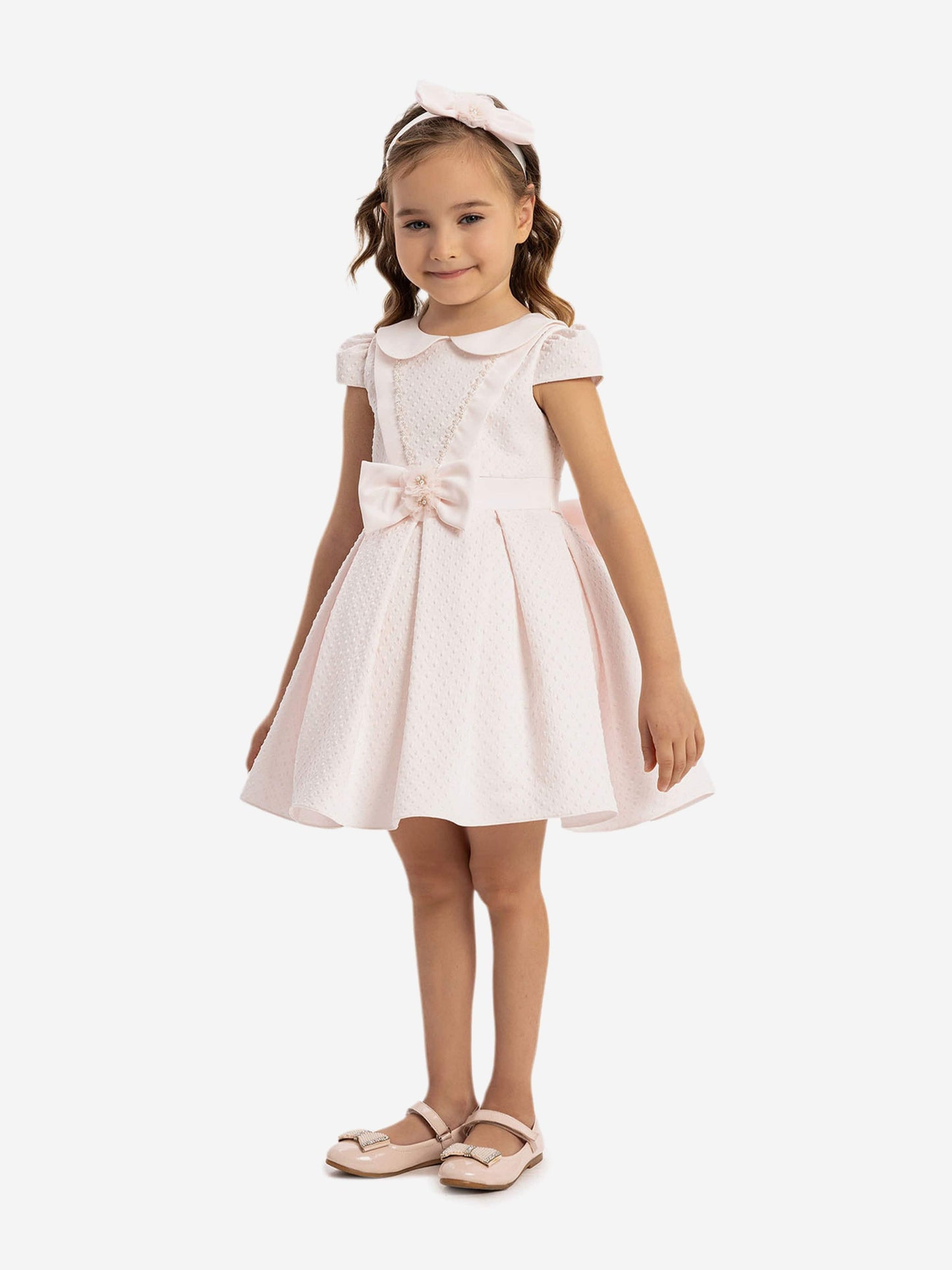 Pink baby dress with large bow at waist and pale pink flower headband