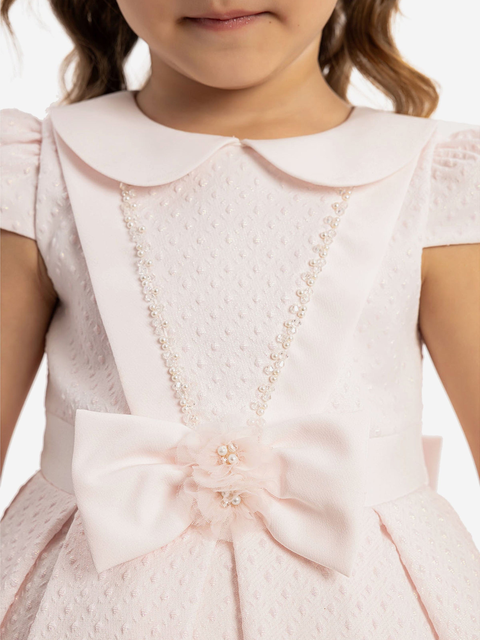 Pink dress bodice with beaded V trim and bow accent at the waist, short sleeves