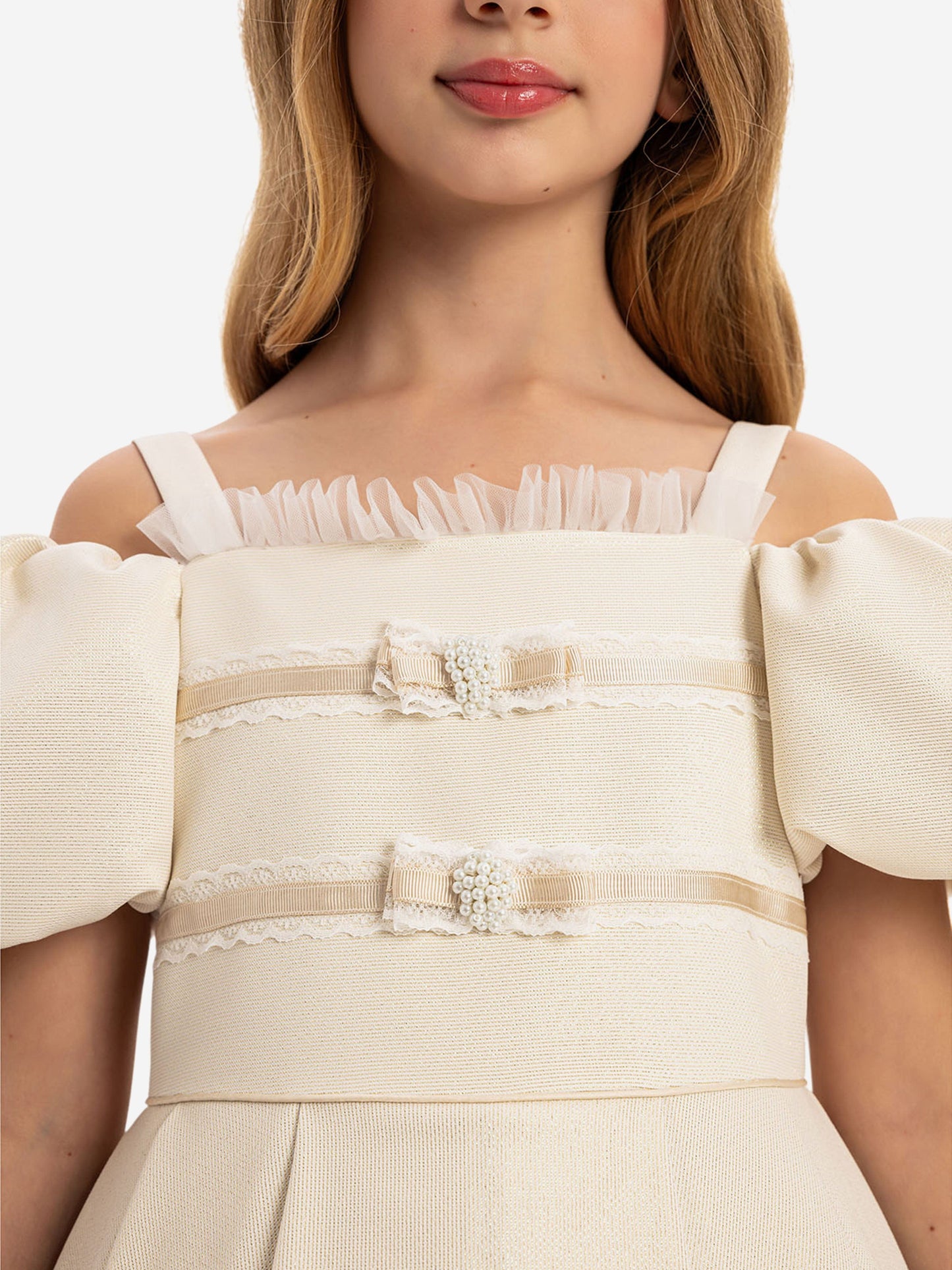 Beige dress bodice close-up with ruffled neckline and embroidered lace trims