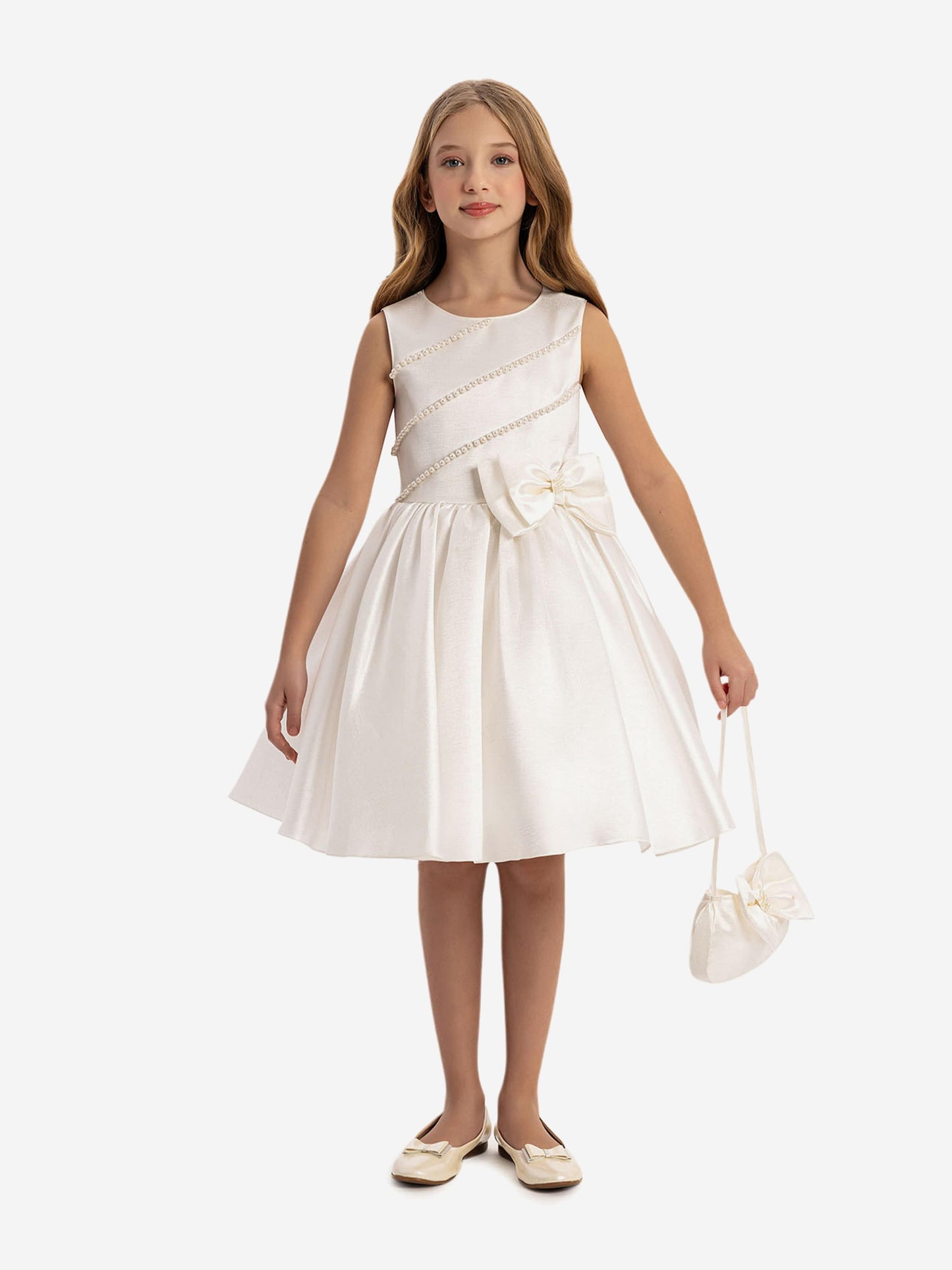 White satin girls dress with waist bow, pearl trim, and matching mini bag