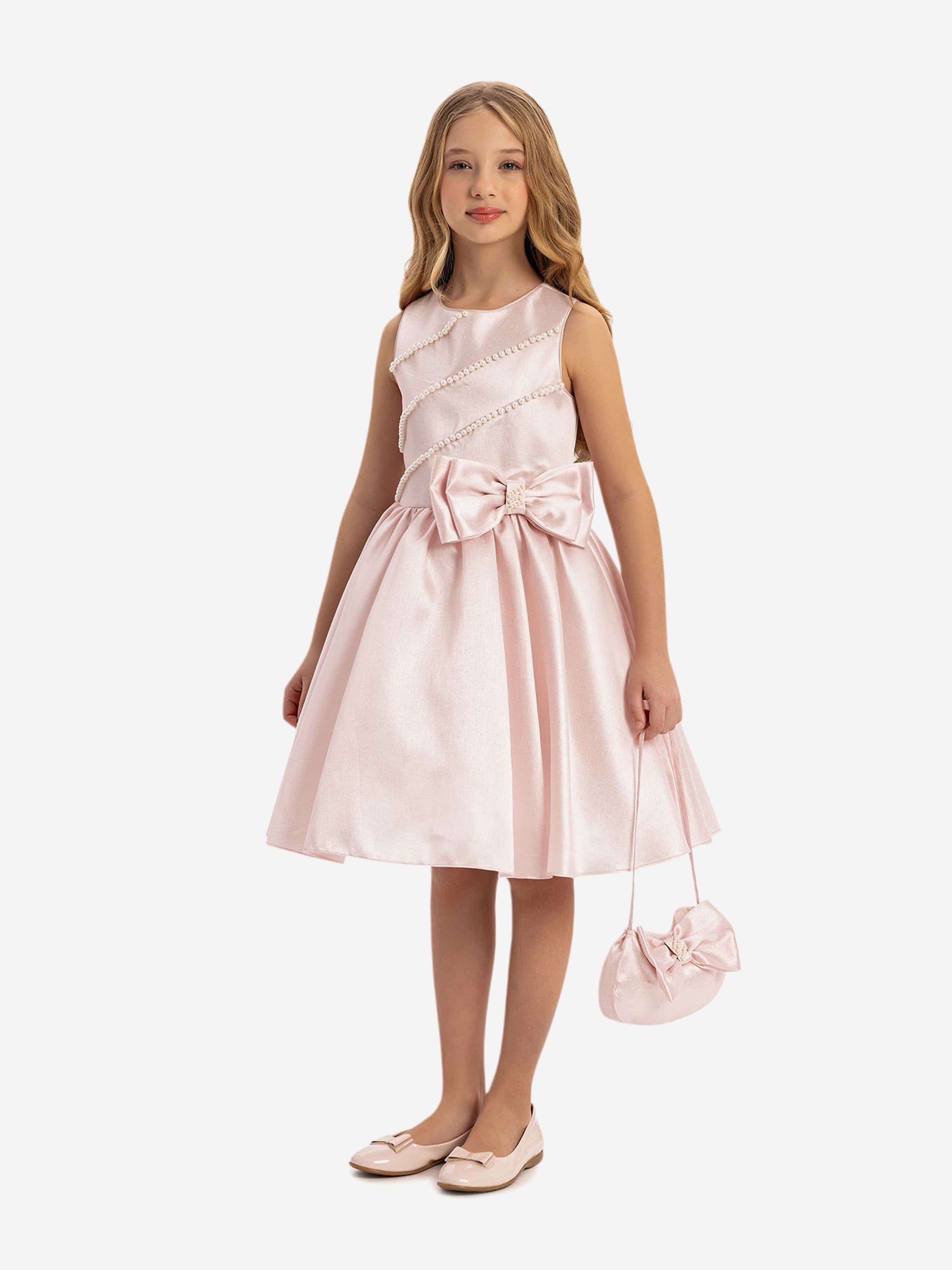Girls pink satin dress with pearl trim and large bow at waist, plus mini bag