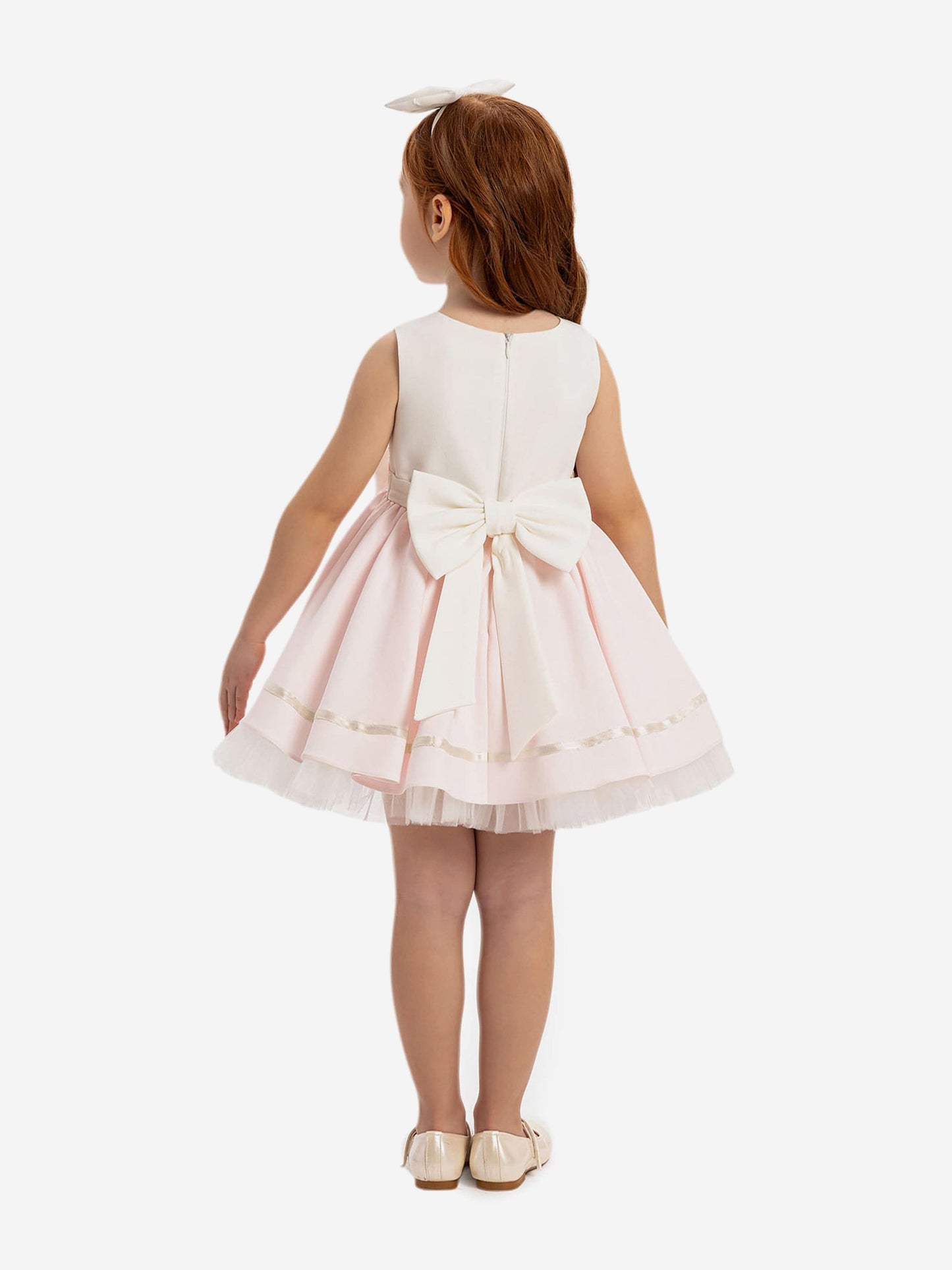 Pink-and-white dress with large back bow and layered tulle skirt