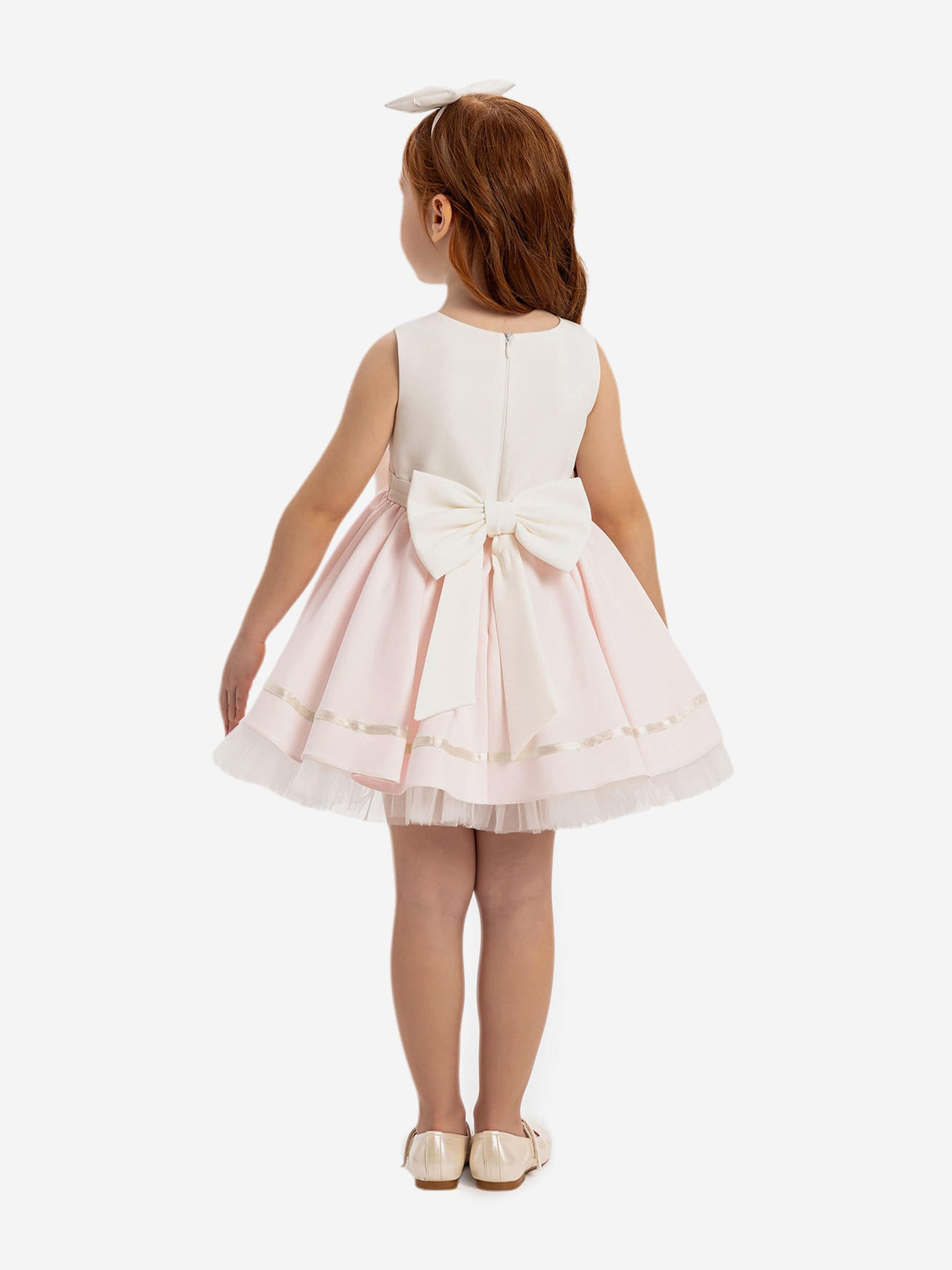 Pink-and-white dress with large back bow and layered tulle skirt