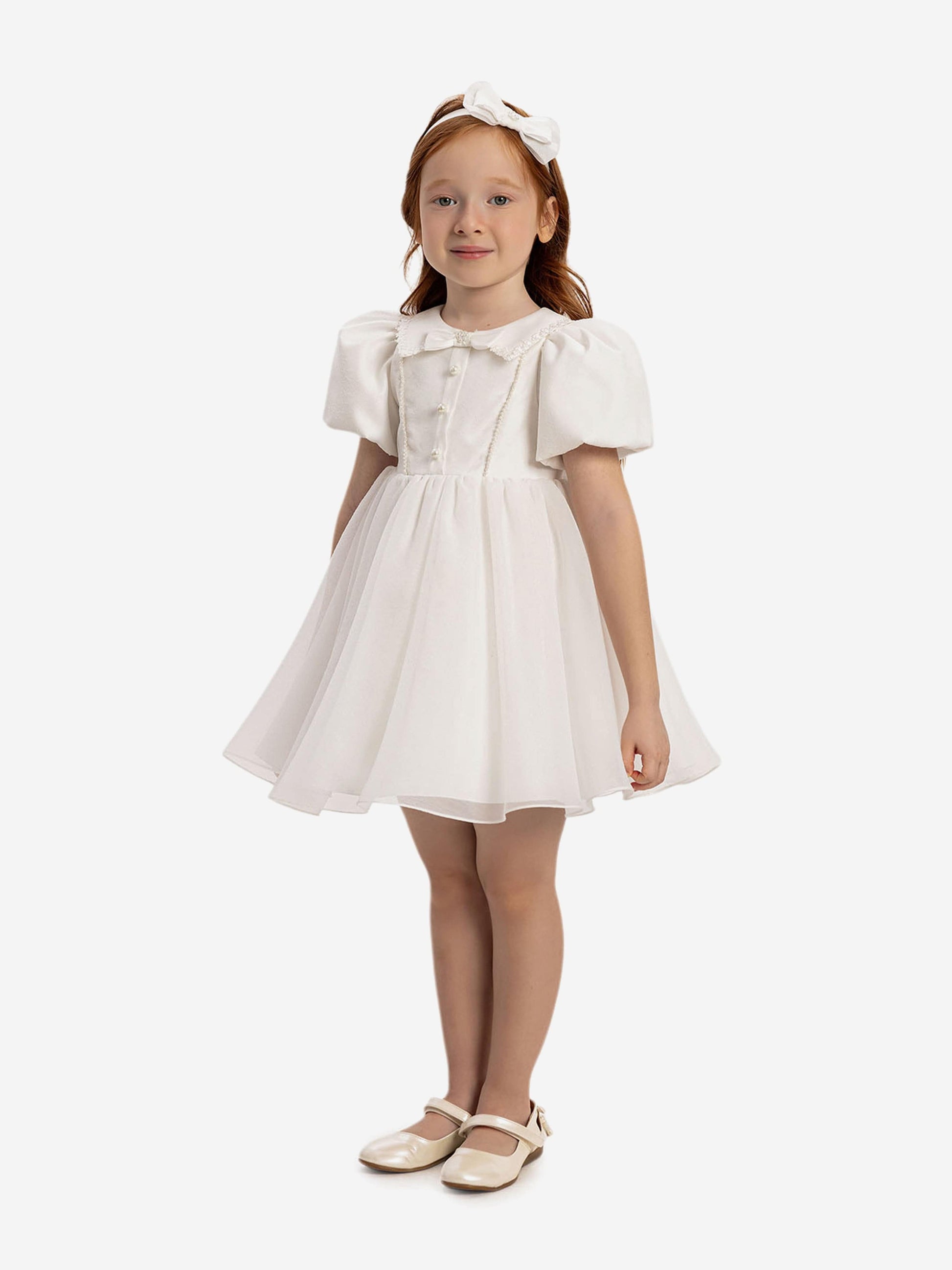 White baby dress front with puff sleeves, pearl-trimmed buttons and headband