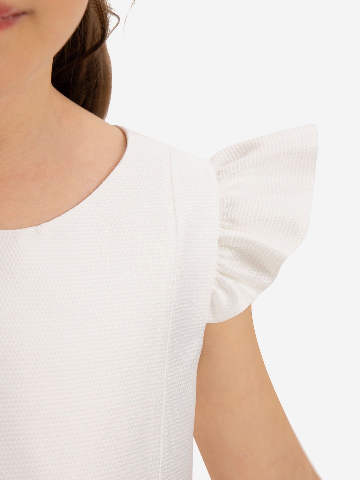 Close-up girls white dress with puff sleeves and simple rounded neckline