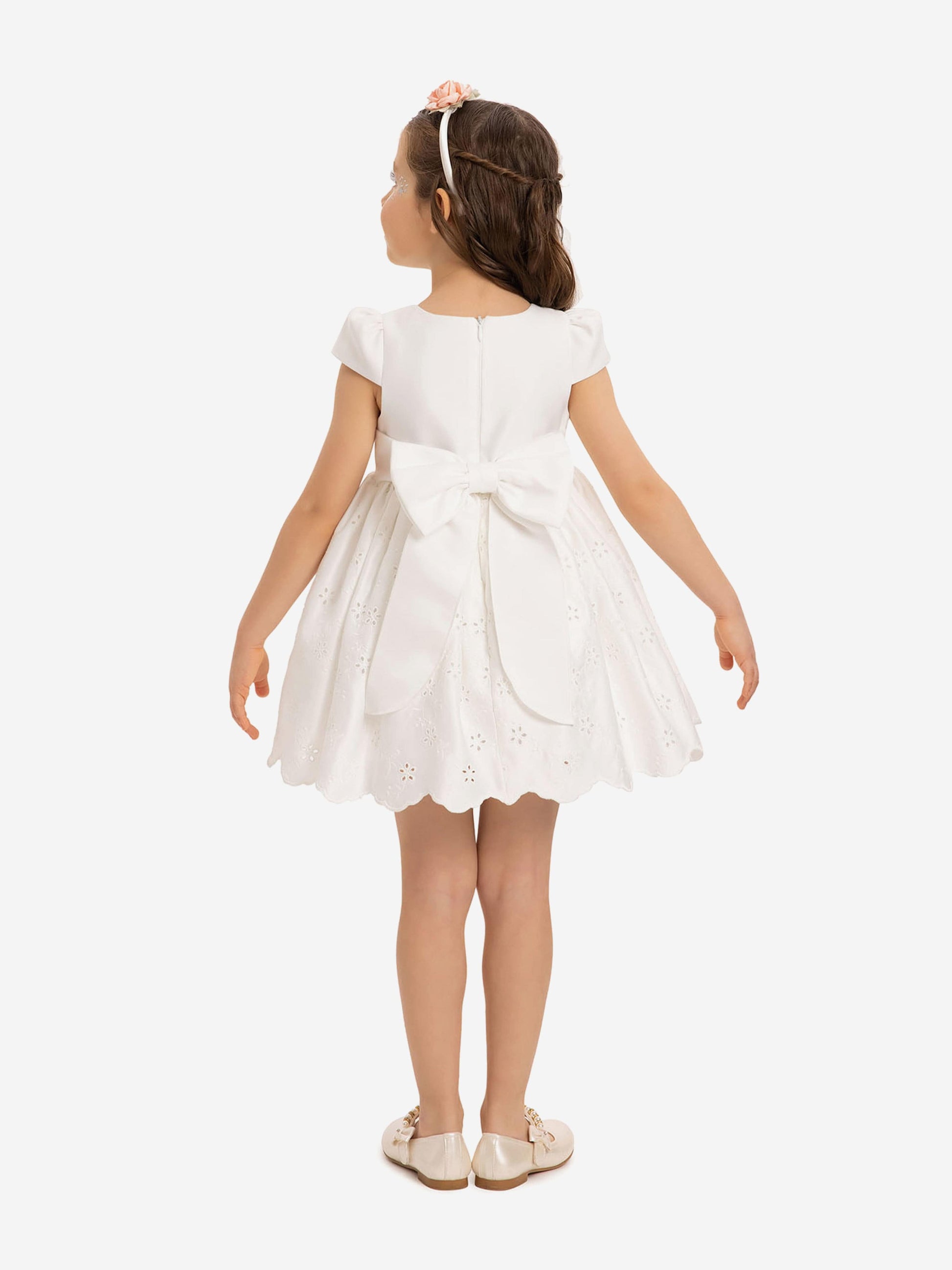 White baby dress back view with bow at waist and scalloped eyelet skirt