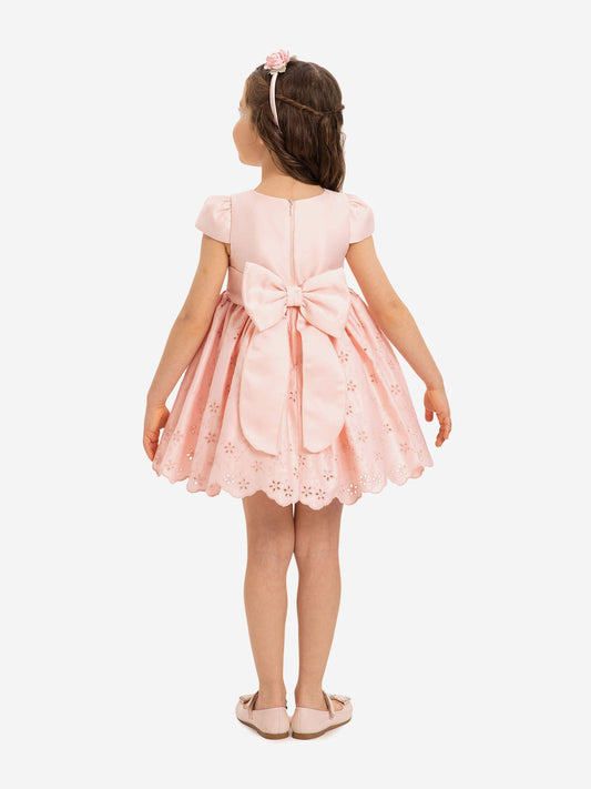 Back view pink dress with tied bow at center and scalloped skirt hem